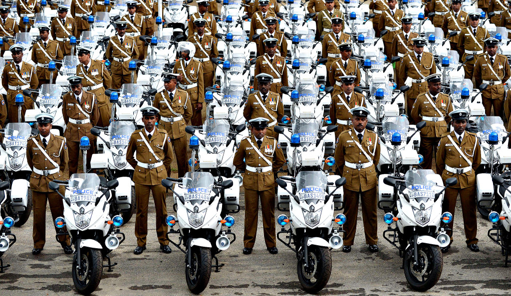 Sri Lankan policemen stand next to their...Sri Lankan policemen