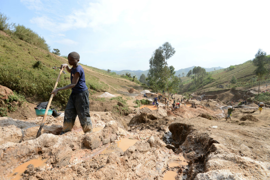A child separates mineral from rock and sand at a mine in DR Congo (Picture: AFP/Stringer) 