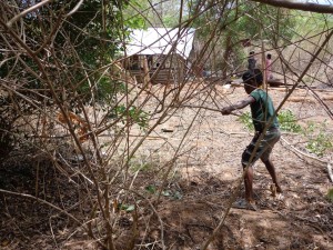 Rajinis son clearing the jungle around their home