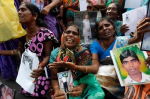 Tamil women in Jaffna, Sri Lanka, on Aug. 27, holding images of their family members, who reportedly went missing during the war between the Sri Lankan army and the separatist group, Liberation Tigers of Tamil Eelam.