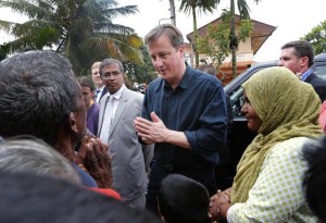 British Prime Minister David Cameron talks to villagers of an IDP camp in Jaffna on Friday.