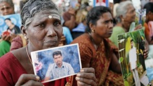 Sri Lankan ethnic Tamil women cry holding portraits of their missing relatives during a protest in Jaffna, Sri Lanka