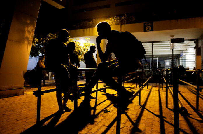 Sri Lankans gather outside the Immigration and Emigration Department to get their passports to leave the country amid the country's economic crisis